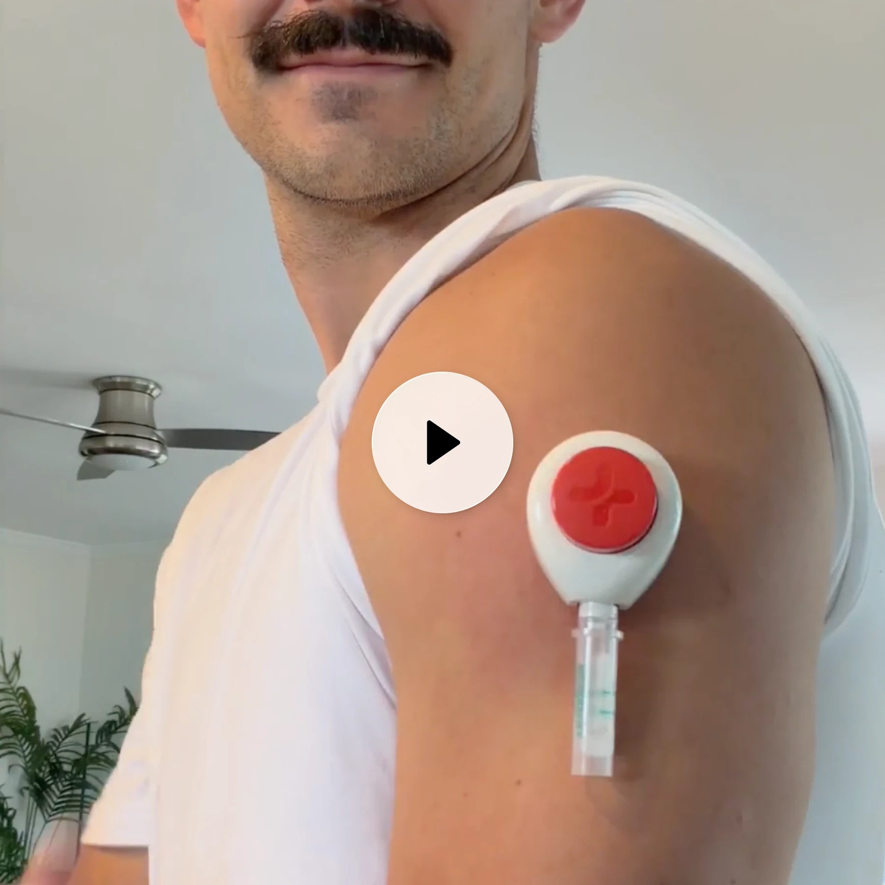 Person sitting on a couch wearing a continuous glucose monitor on the arm, with labels indicating painless use, at-home collection, and results in 72 hours.