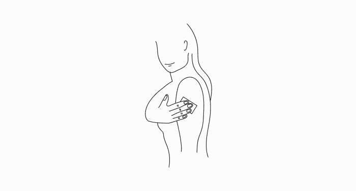 A simple line drawing of a person pressing a small device against the back of their upper arm.