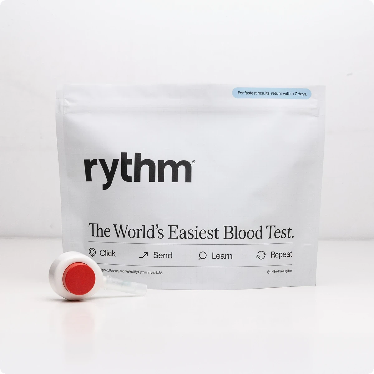 Rythm at-home blood test kit package placed on a wooden surface, showing branding and product details.