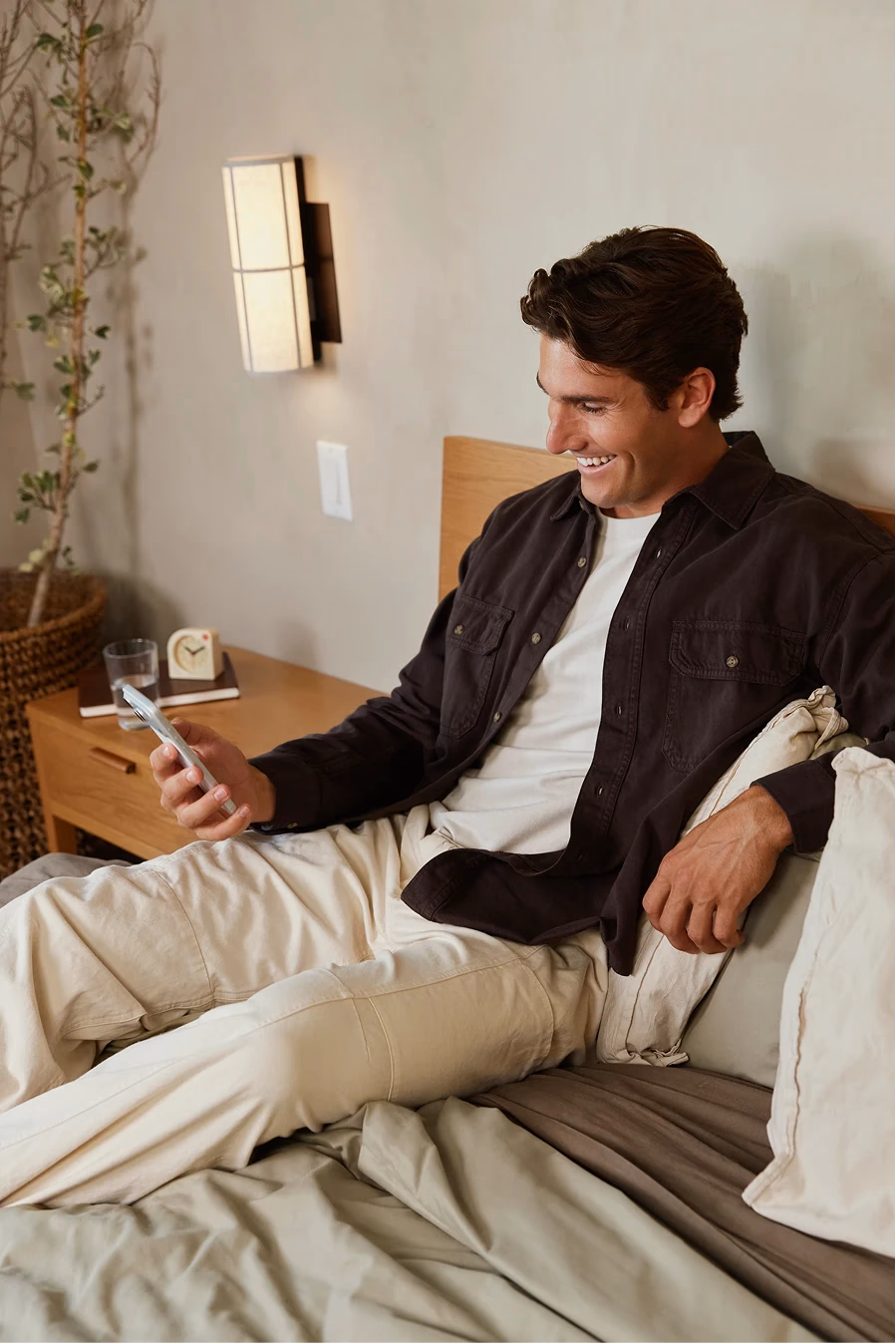 Person holding a smartphone displaying the Rythm Health app, showing a hormone score and health metrics on screen.