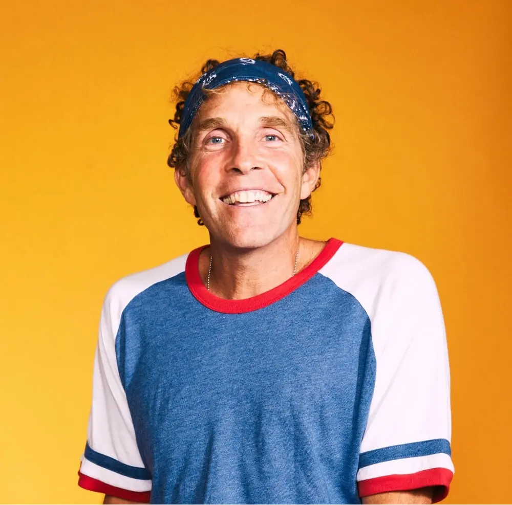 Jesse smiling against a studio background, representing the Rythm Health community.