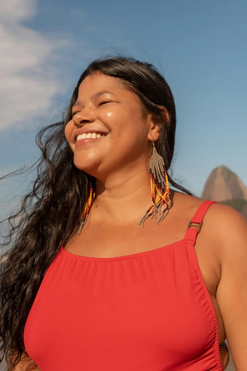 Smiling woman with clear glowing skin, doing the rythm at home blood collection representing healthy skin and internal health