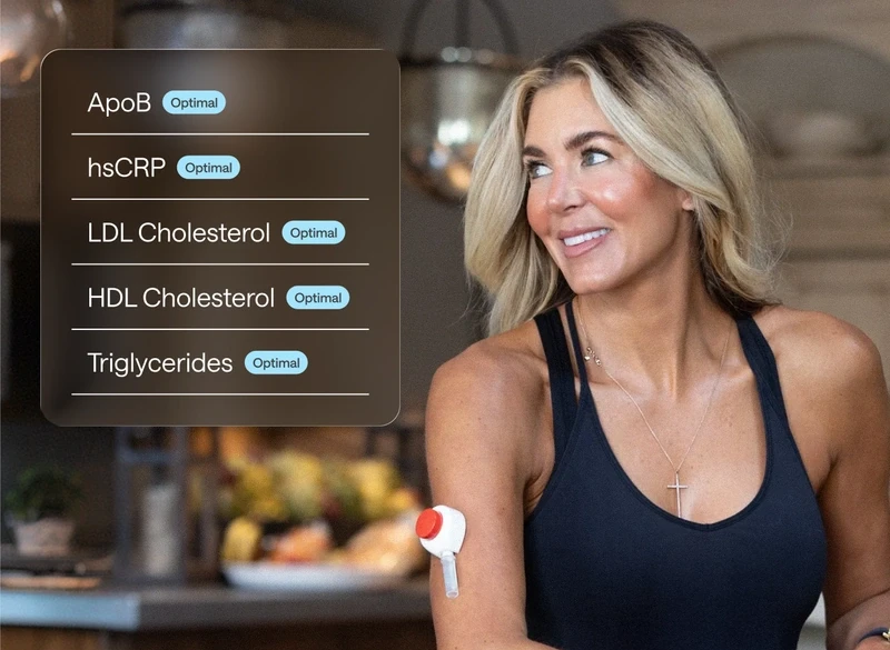 Smiling woman with clear glowing skin, doing the rythm at home blood collection representing healthy skin and internal health