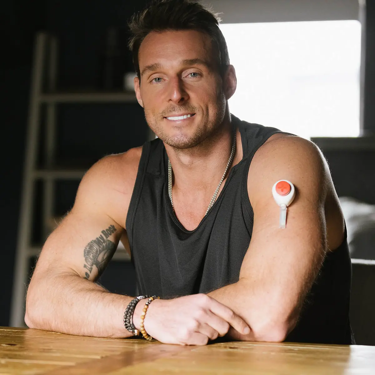 Dream indoors showing a Rythm Health sensor on his upper arm.