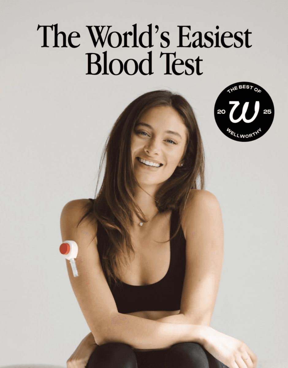 Woman sitting and smiling with a Rythm device on her arm, with text “The World’s Easiest Blood Test.”